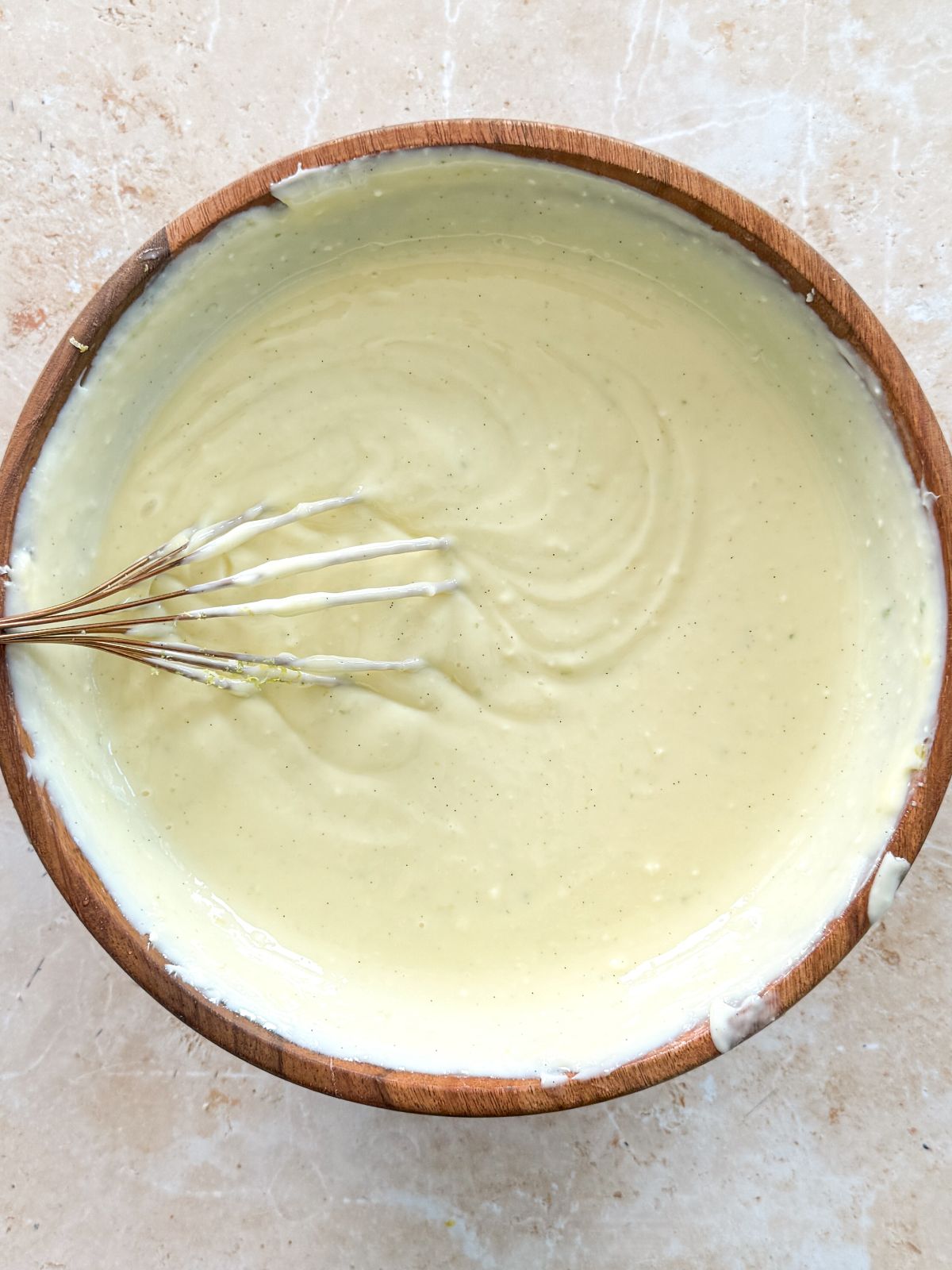 smooth and creamy key lime pie filling in a wooden bowl