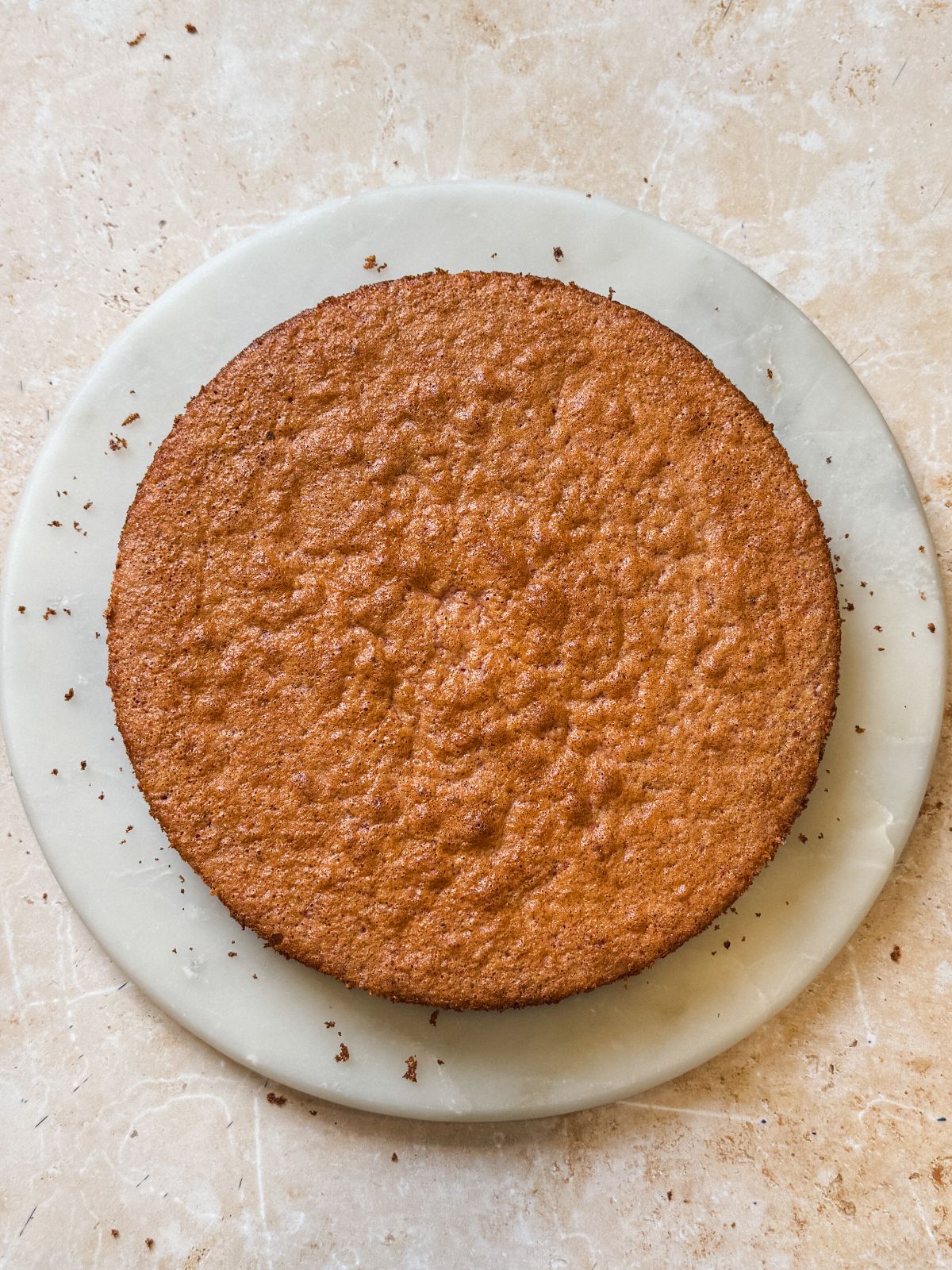 baked strawberry chiffon cake on a cake board. cake looks light and golden
