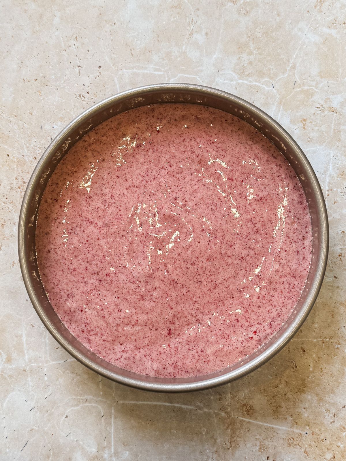 strawberry chiffon cake batter in a round cake oan