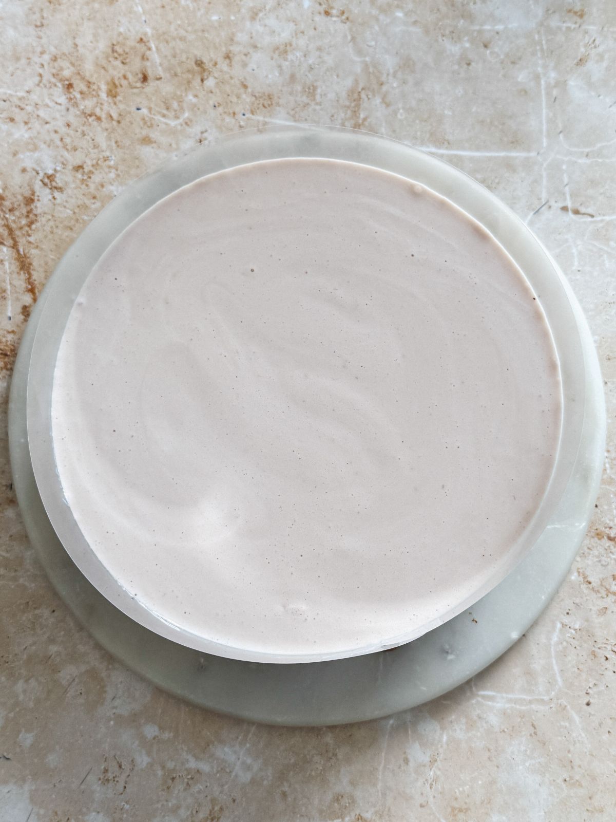 layer of strawberry mousse added on top of chocolate mousse when assembling neopolitan ice cream mousse cake