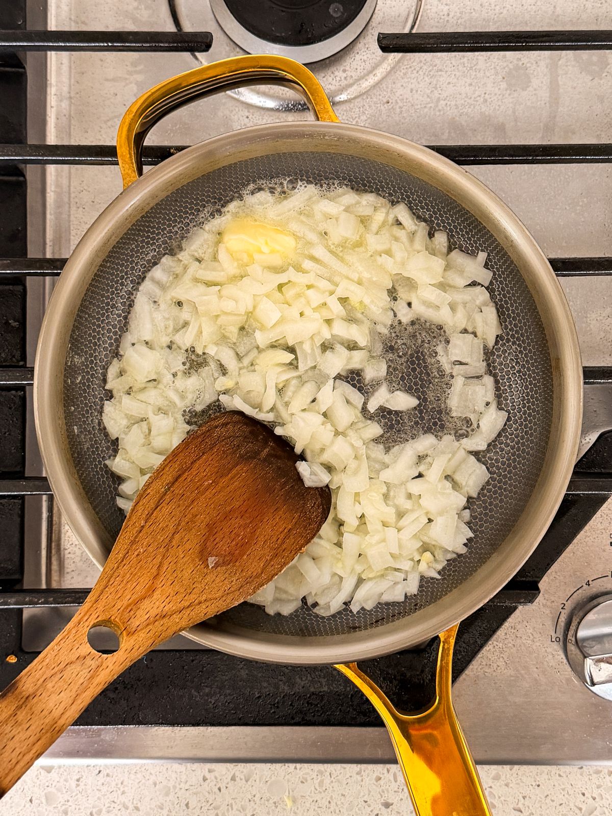 finely chopped onion being sautéed in butter in a small saucepan