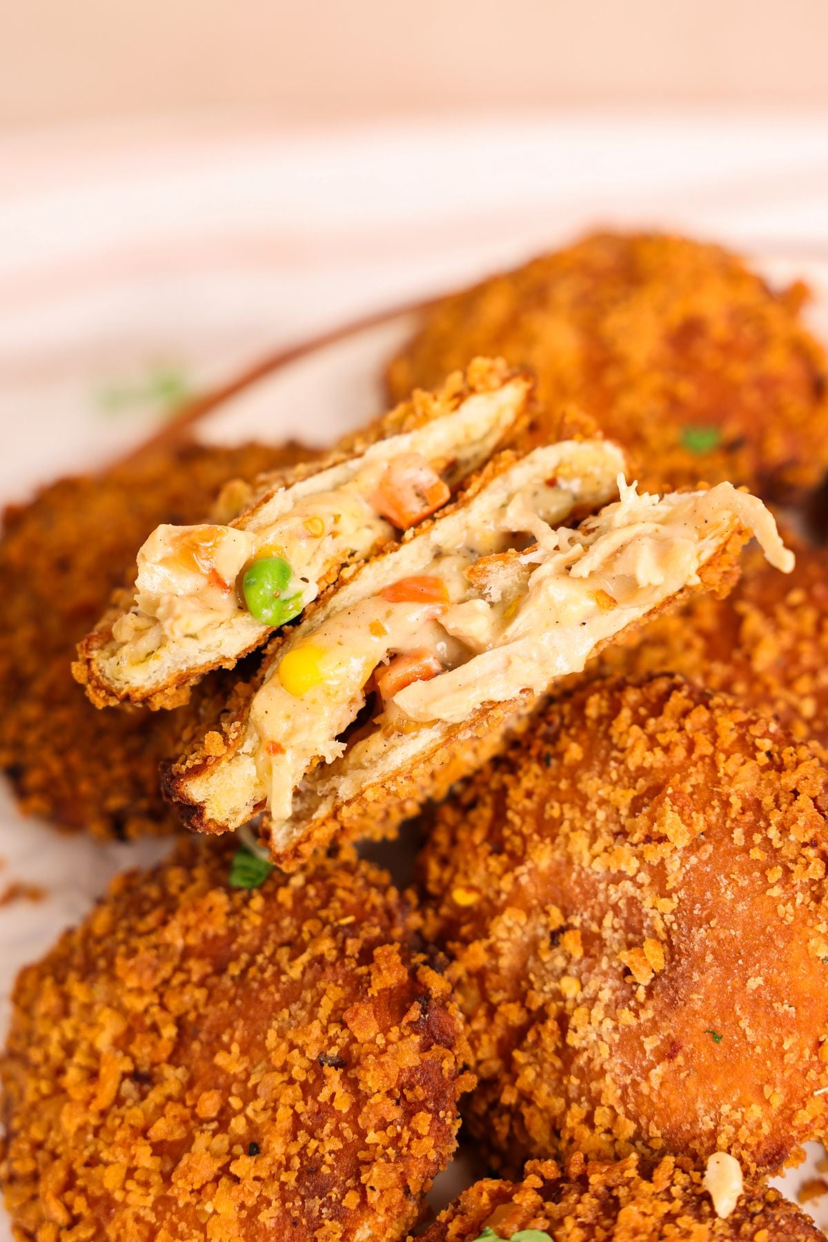 fried pot pie bread pocket halves stacked together to show the crispy crunchy shell and creamy chicken filling