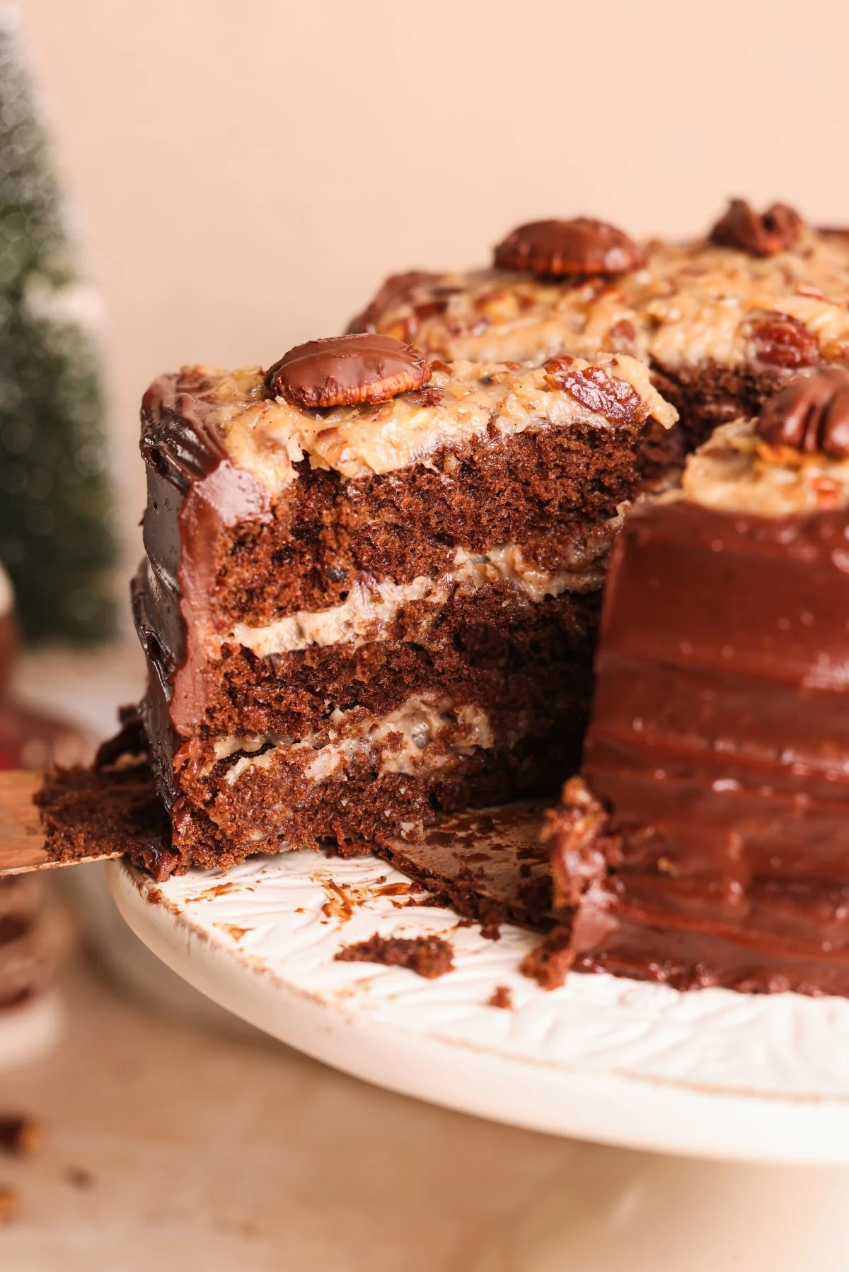 A german chocolate cake with nuts on top.