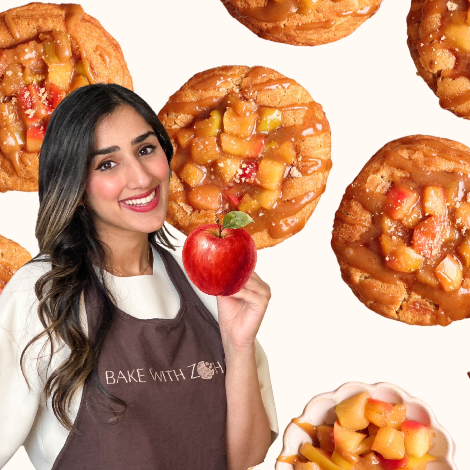 A smiling woman in a Bake With Zoha apron holds an apple, surrounded by mini apple pies and a bowl of diced apples on a light background.